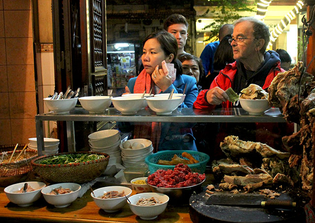 Không hiếm khi bắt gặp những vị khách nước ngoài đứng xếp hàng đợi thưởng thức phở Hà Nội.